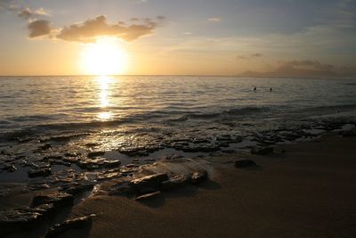 Scenic view of beach against sky during sunset