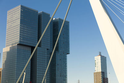 Low angle view of modern buildings against clear blue sky