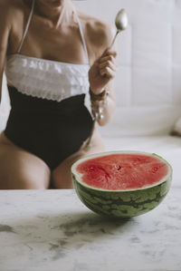 Midsection of woman holding ice cream in bowl