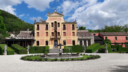 Historic buildings against cloudy sky