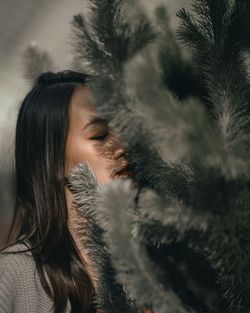 Close-up of woman with hair and tree