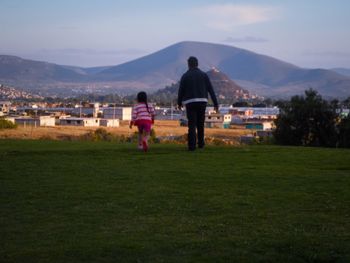 Rear view of people on golf course