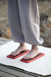 Low section of woman standing on footpath