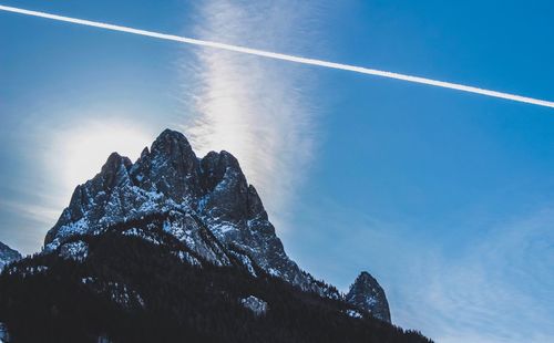 Low angle view of vapor trail against blue sky