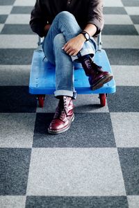 Low section of man sitting on road