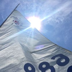 Low angle view of sailboat canvas against bright sky
