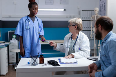 Female doctor explaining to patient in office