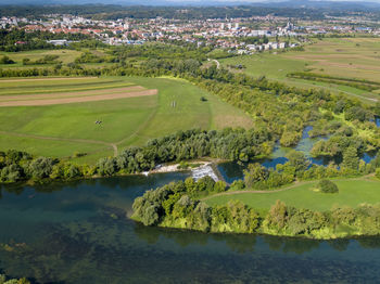 Scenic view of lake by buildings against trees