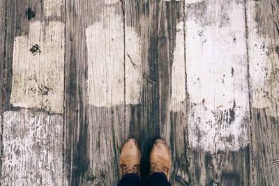 Low section of person on wooden floor