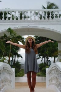 Full length of woman standing by swimming pool