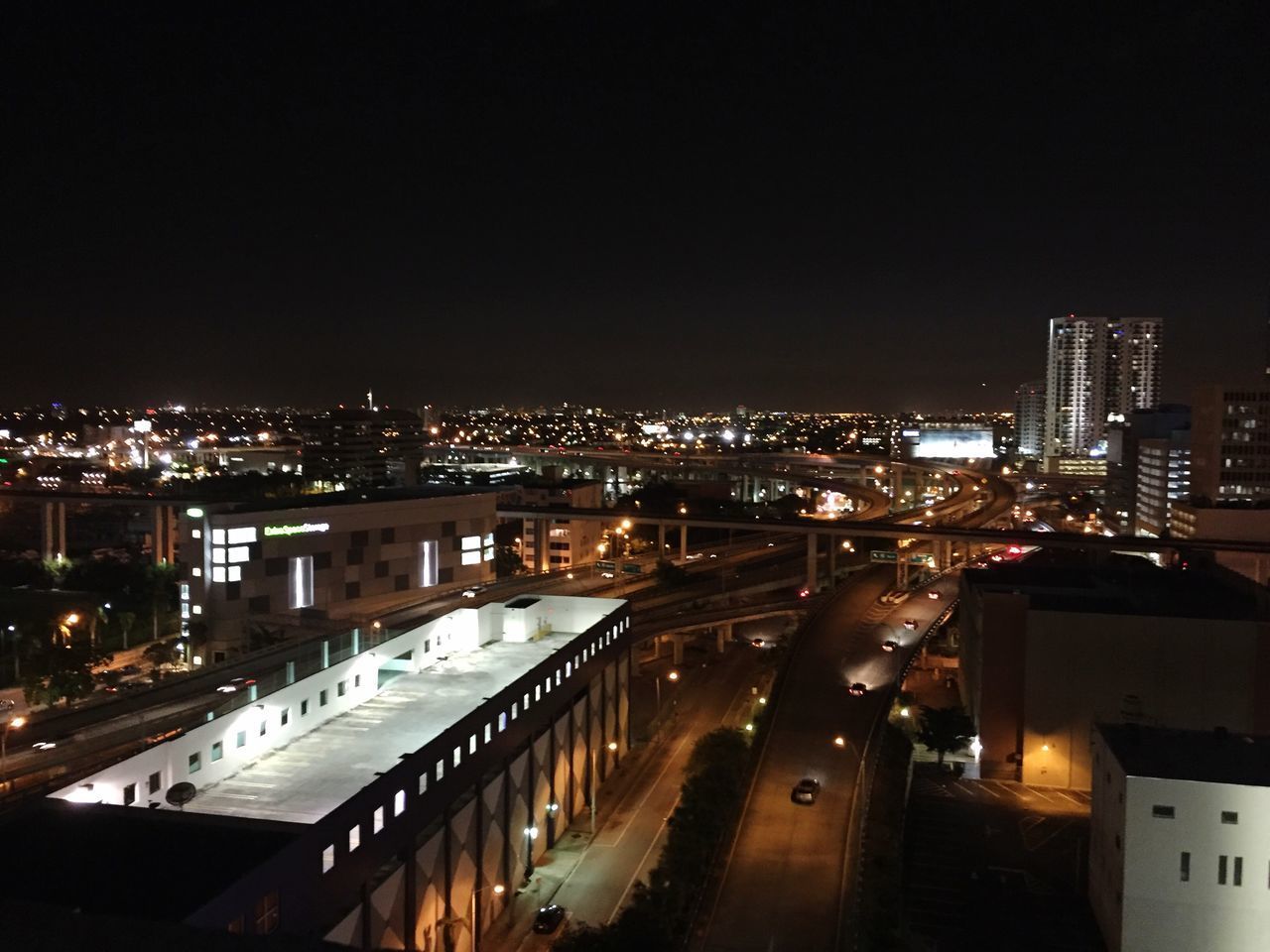 ILLUMINATED CITYSCAPE AGAINST SKY