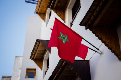 Red flag of morocco waving in the wind background outside