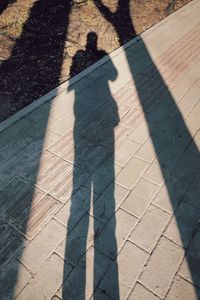 Shadow of people on footpath