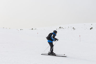 Full length of person skiing on snowcapped mountain during winter