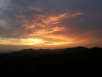 Scenic view of silhouette mountains against sky during sunset