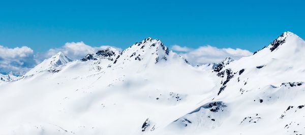 Low angle view of snow covered mountain against sky