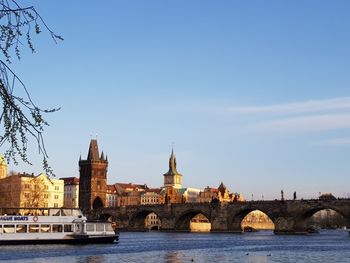 Arch bridge over river against sky