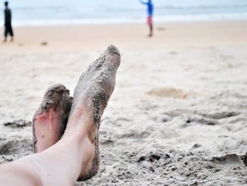 Sand covered feet on a beach