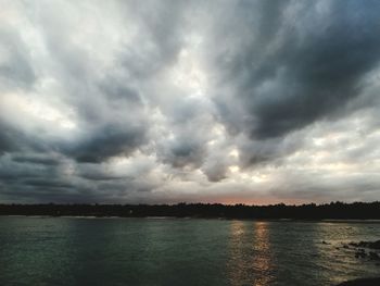 Scenic view of lake against cloudy sky