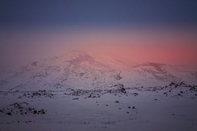 Aerial view of snowcapped mountain against sky during sunset