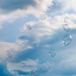 Low angle view of bubbles against sky