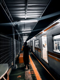 Rear view of man on train at railroad station