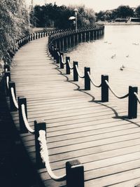 Empty wooden pier on footpath