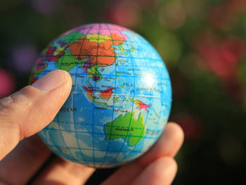 Close-up of human hand holding leaf