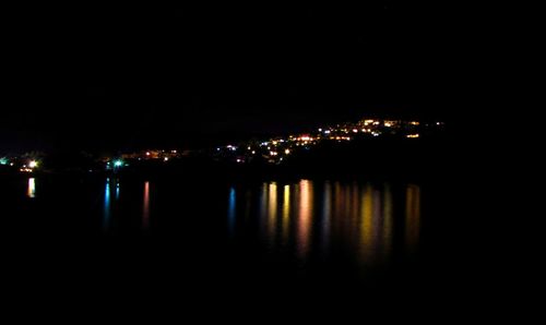 Reflection of illuminated buildings in calm water