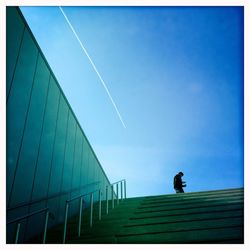 Low angle view of modern building against blue sky