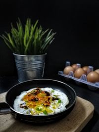 High angle view of fried egg in cooking pan on table