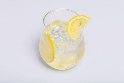 Close-up of drink in glass against white background