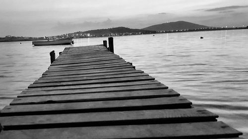 Pier over lake against sky