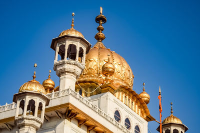 Low angle view of church against clear blue sky