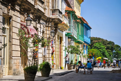 People on street amidst buildings in city