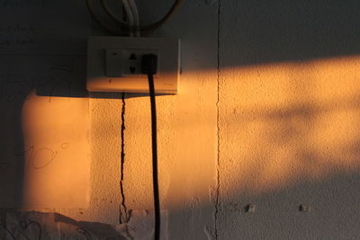 Close-up of electric lamp on wall
