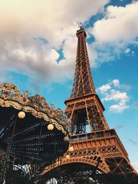 Low angle view of eiffel tower against cloudy sky