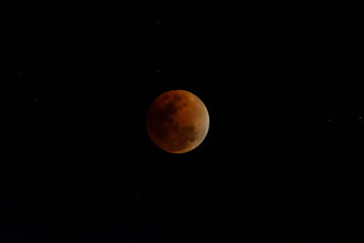 Low angle view of moon against clear sky at night