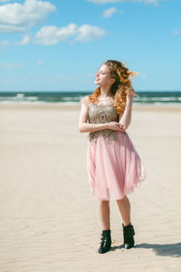 Full length of woman standing on beach