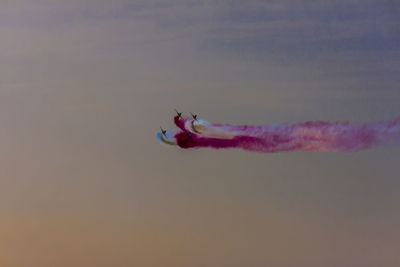 Low angle view of airplane flying against sky