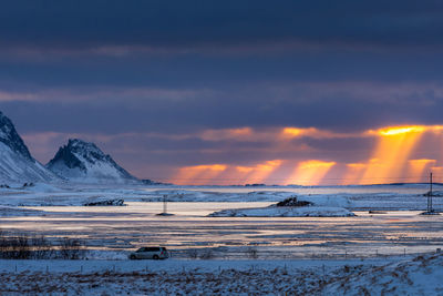 Scenic view of snowcapped mountains against sky during sunset