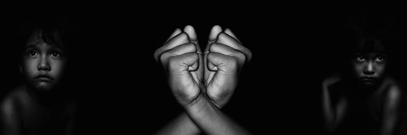 Close-up of human hand against black background