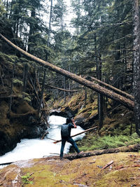 Man photographing through camera in forest