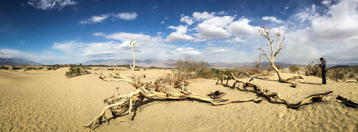 Scenic view of desert against cloudy sky