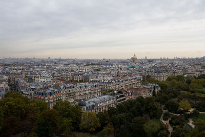 Buildings in city against cloudy sky