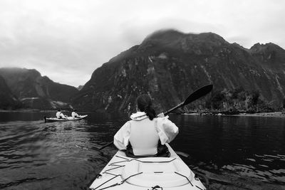 Rear view of woman canoeing