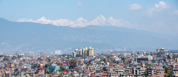 High angle view of buildings in city against sky