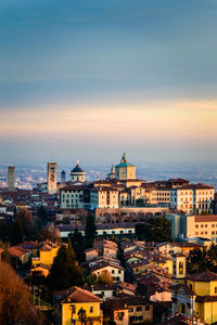 Cityscape against sky at sunset