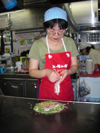 Mid adult woman holding food in kitchen