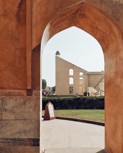 Buildings seen through arch entrance of building at jantar mantar jaipur